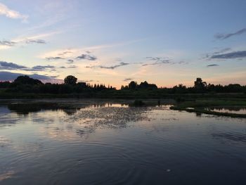 Scenic view of lake against sky at sunset