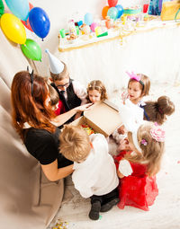 Group of people with balloons at home