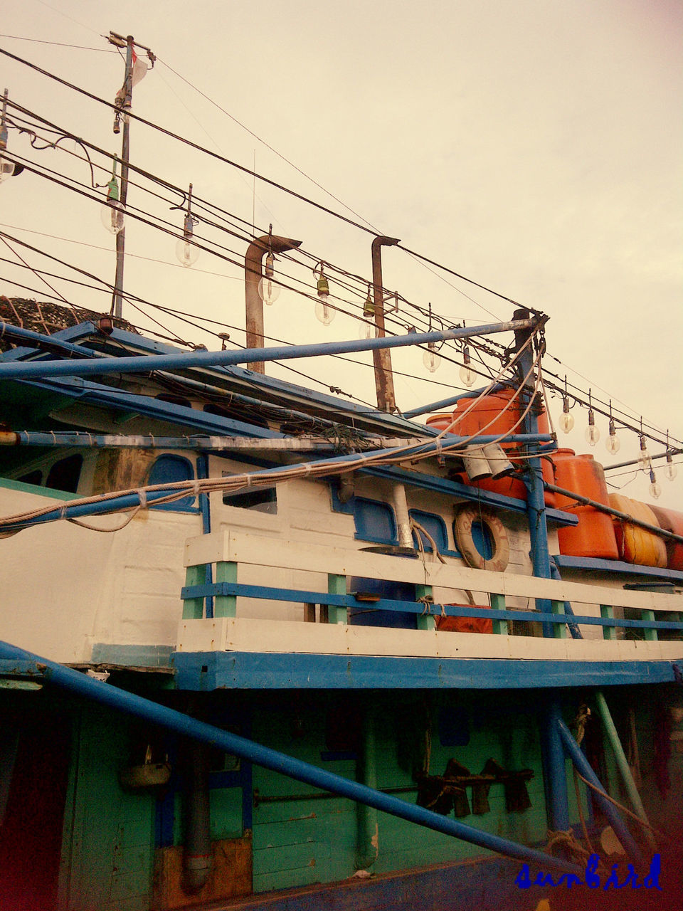 transportation, clear sky, mode of transport, built structure, architecture, nautical vessel, sky, graffiti, low angle view, building exterior, day, outdoors, public transportation, no people, text, rail transportation, train - vehicle, western script, moored, boat