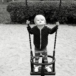 Portrait of girl swinging in playground