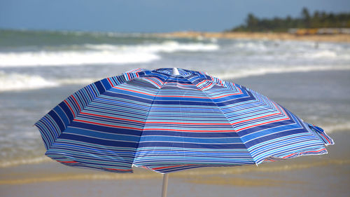 Close-up of umbrella on beach