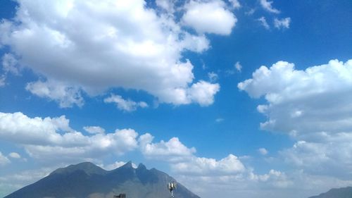 Scenic view of mountains against cloudy sky