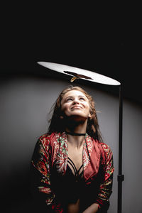 Woman by lighting equipment