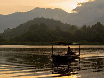 Scenic view of lake against sky during sunset