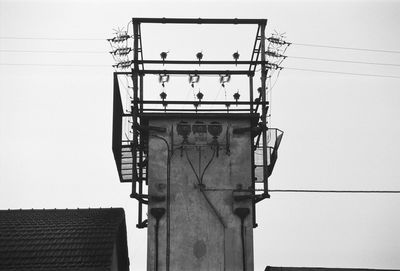 Low angle view of electricity pylon against sky