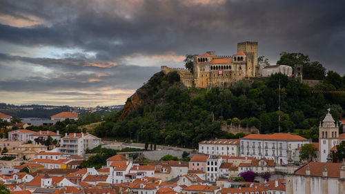 Buildings in town against sky