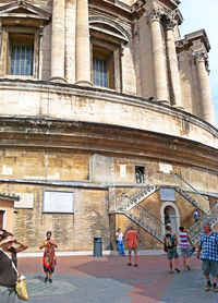 People walking in front of building