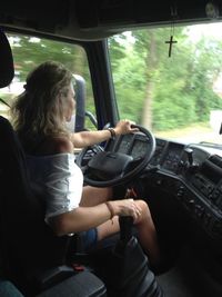 Rear view of woman sitting in car