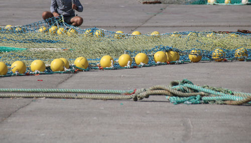 Low section of fisherman holding fishing net outdoors