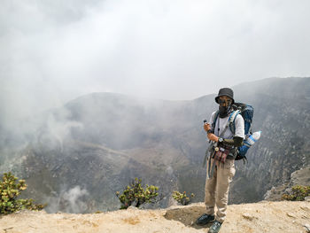 Man standing on mountain against mountains