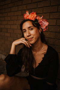 Woman looking at camera with flowers and long hair