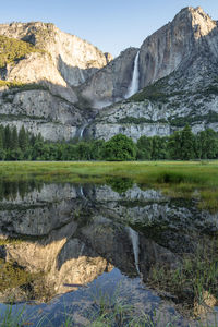 Scenic view of lake with mountain range in background