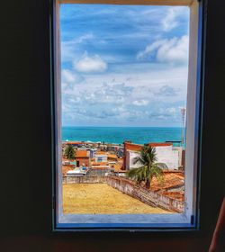 Scenic view of sea seen through glass window