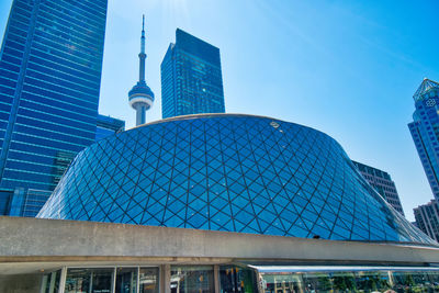 Low angle view of modern buildings against blue sky