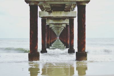 Pier over sea against sky