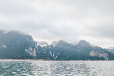 Scenic view of sea and mountains against sky