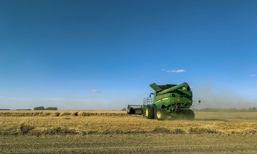 John deere combine working hard to finish the harvest