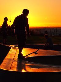 People in water at sunset