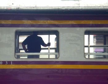 Man and train at railroad station platform