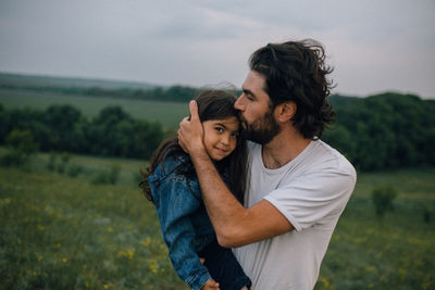 Young couple kissing on land