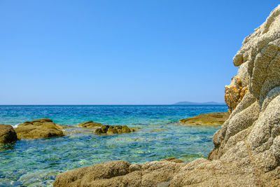 Scenic view of sea against clear blue sky