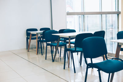 Empty chairs and table in room