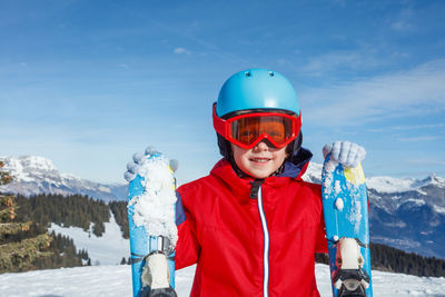 Portrait of young woman standing on snow