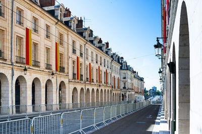 Street amidst buildings against sky in city