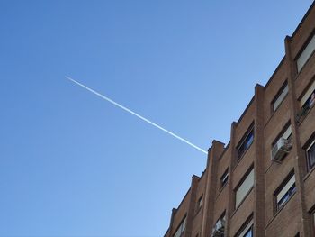 Low angle view of vapor trails in sky