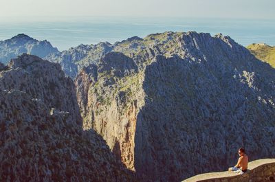 Panoramic view of rocks and sea against sky