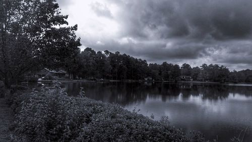 Scenic view of calm lake against cloudy sky