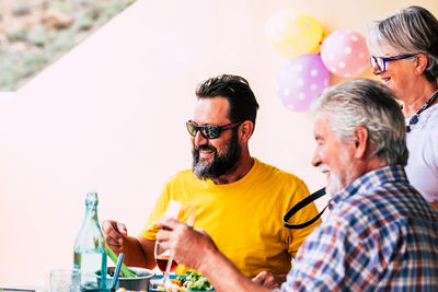 Cheerful family having food on table