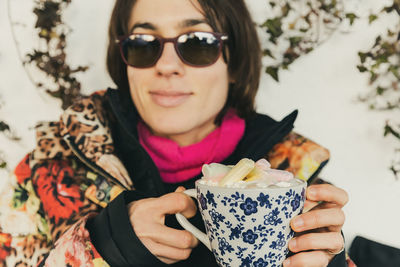 Portrait of smiling woman holding drink