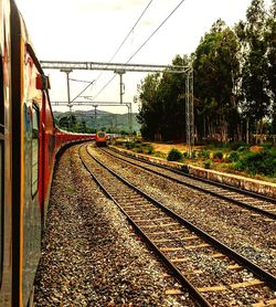 Train at railroad station against clear sky