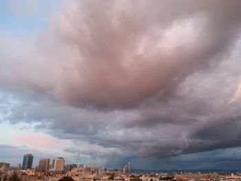 Cityscape against cloudy sky