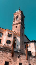 Low angle view of old building against clear blue sky