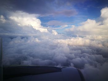 Aerial view of cloudscape over airplane wing