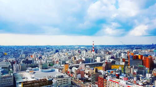 High angle view of cityscape against cloudy sky