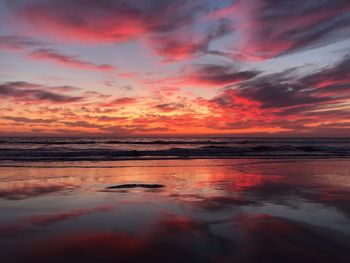 Scenic view of sea against romantic sky at sunset