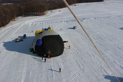 High angle view of people skiing on snow covered field