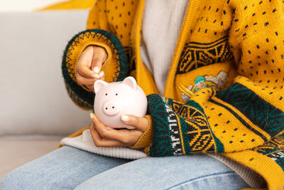 Midsection of woman holding teddy bear