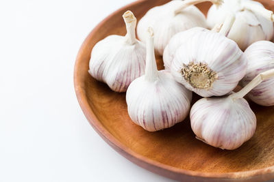 Close-up of garlic on white table
