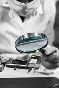 Close-up of man working on metal