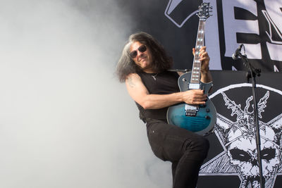 Full length portrait of man with arms outstretched