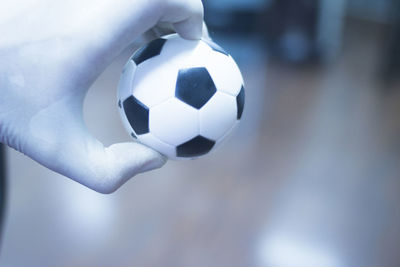 Close-up of hand holding soccer ball