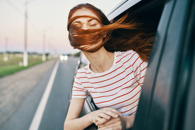 Portrait of young woman in car