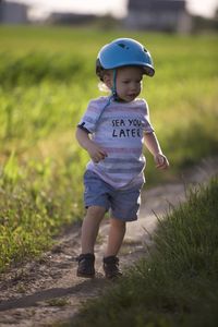 Full length of boy standing on field