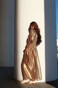 Side view of woman statue against wall