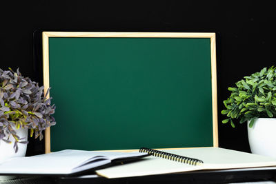 Open book on table against wall