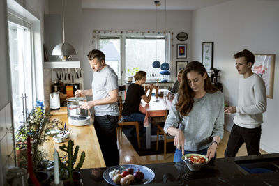 Family preparing food in kitchen